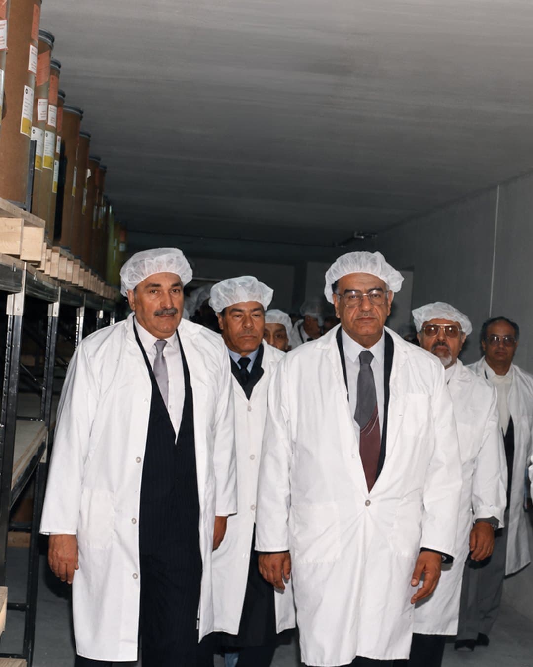 Pharco's founder walking a raw-material store with his team